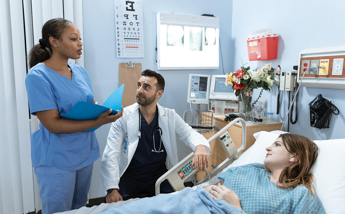Patient and caregivers in a hospital room